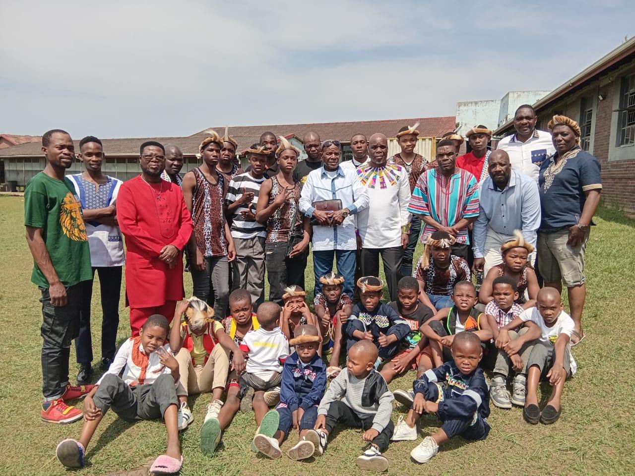 Zulu cultural group with traditional attire and children
